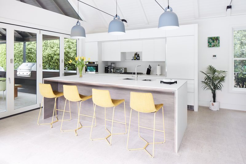 Guest pavilion kitchen with yellow bar stools