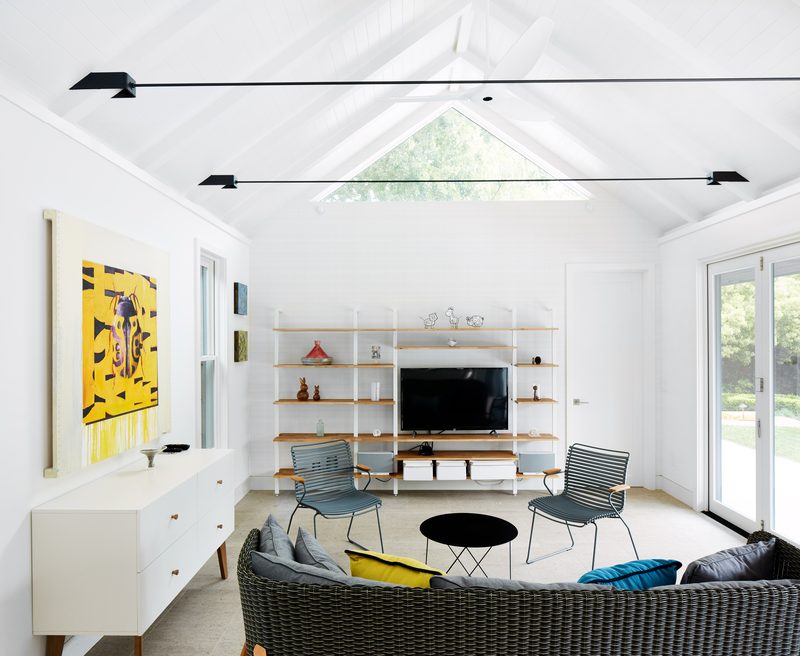 Vaulted living room with skylight and contemporary art