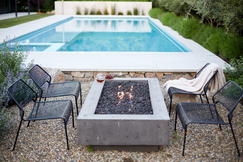 Fire pit and pool at dusk